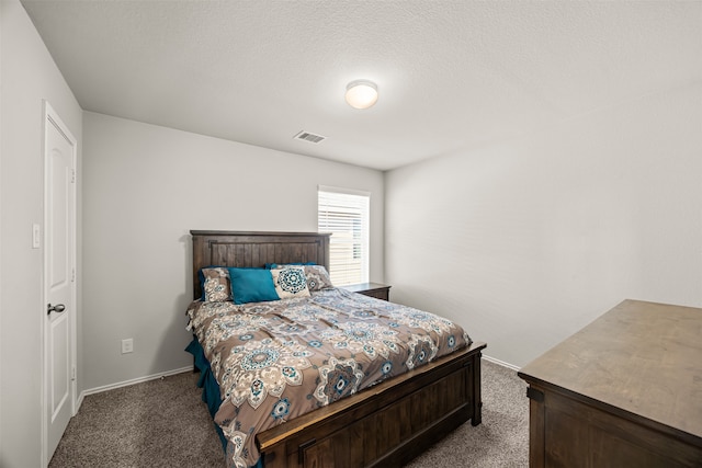 carpeted bedroom featuring a textured ceiling