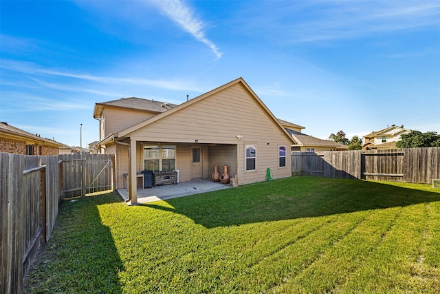 back of property with a yard and a patio area