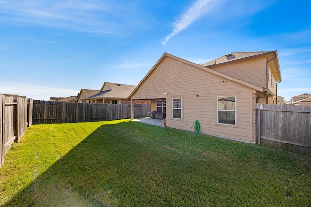 back of property featuring a yard