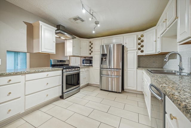 kitchen featuring light stone countertops, sink, white cabinetry, and stainless steel appliances