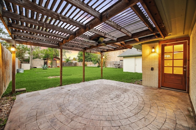 view of patio / terrace with a shed and a pergola