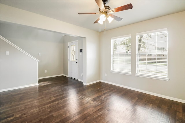 spare room featuring ceiling fan and dark hardwood / wood-style flooring