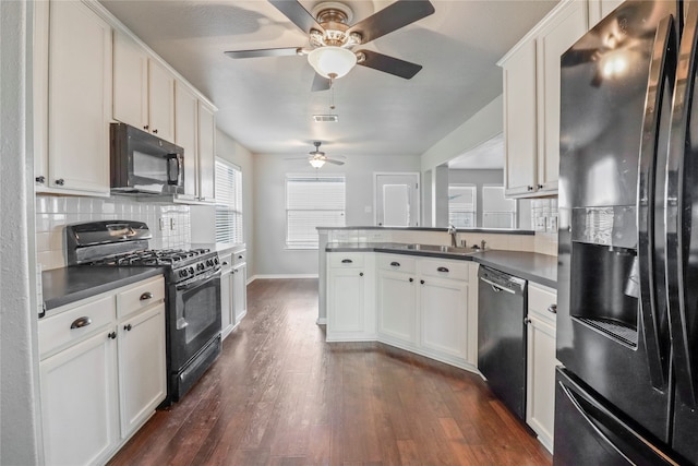 kitchen with white cabinets, black appliances, and dark hardwood / wood-style floors