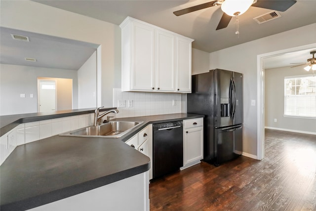 kitchen with sink, dark hardwood / wood-style flooring, white cabinetry, and black appliances