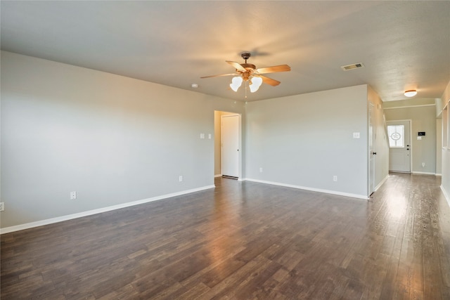 spare room featuring ceiling fan and dark hardwood / wood-style floors