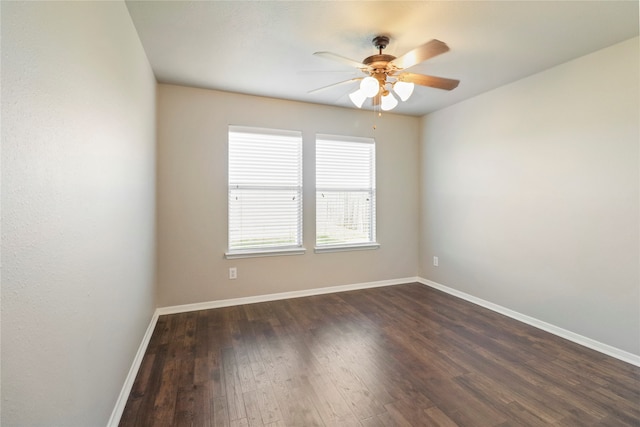 unfurnished room featuring ceiling fan and dark wood-type flooring