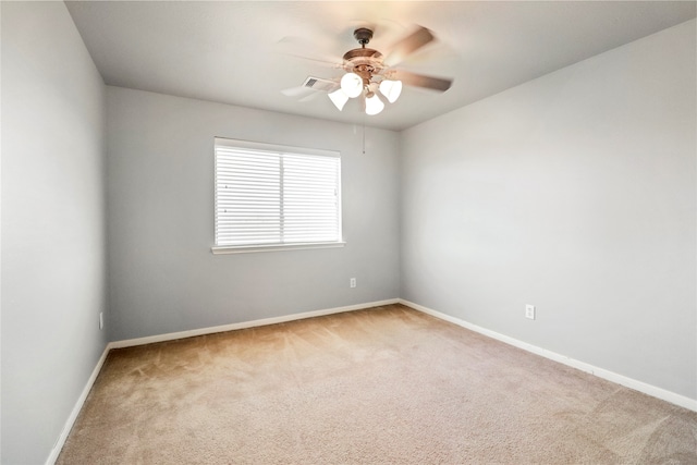 carpeted empty room featuring ceiling fan