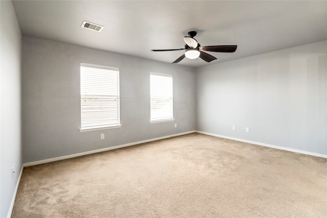 carpeted empty room featuring ceiling fan