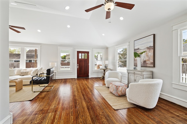 living room with hardwood / wood-style floors, a healthy amount of sunlight, and lofted ceiling