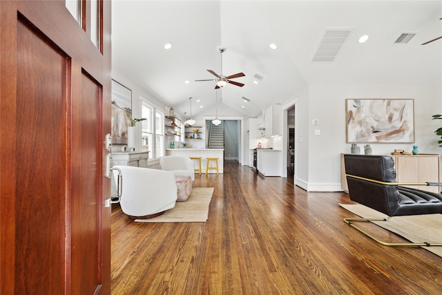 living room with ceiling fan, dark hardwood / wood-style floors, and lofted ceiling