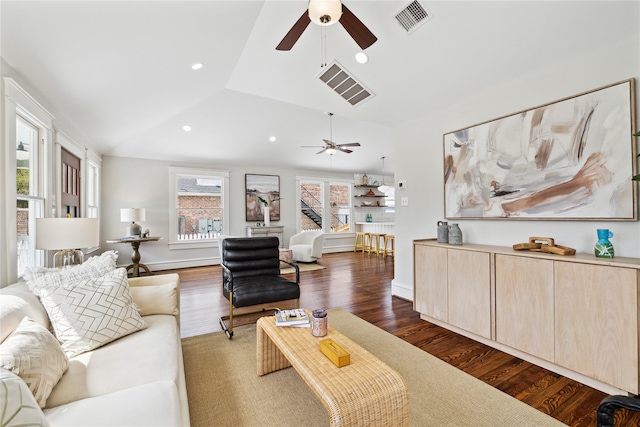 living room with ceiling fan, lofted ceiling, and dark wood-type flooring