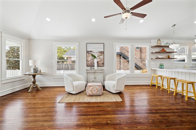 sitting room featuring ceiling fan, dark wood-type flooring, and vaulted ceiling