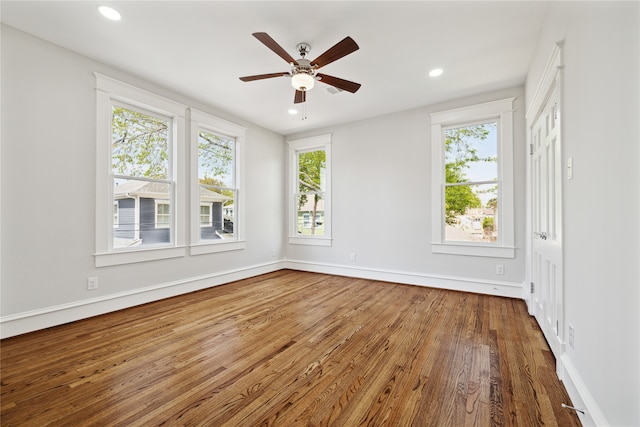 empty room featuring hardwood / wood-style flooring and ceiling fan