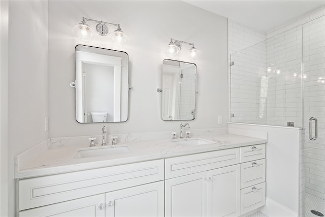 bathroom featuring an enclosed shower, vanity, and toilet