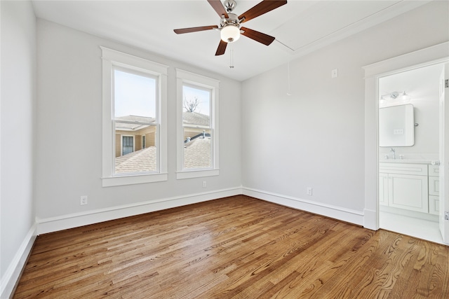 spare room with sink and light wood-type flooring