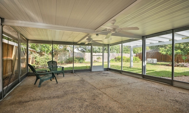 unfurnished sunroom featuring ceiling fan