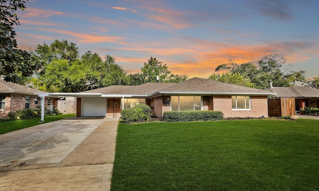 ranch-style home with a yard and a carport