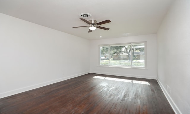 empty room featuring ceiling fan and dark wood-type flooring