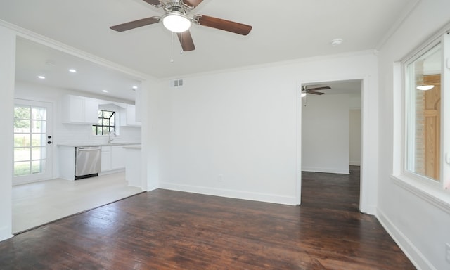 unfurnished living room featuring dark hardwood / wood-style floors, ceiling fan, ornamental molding, and sink