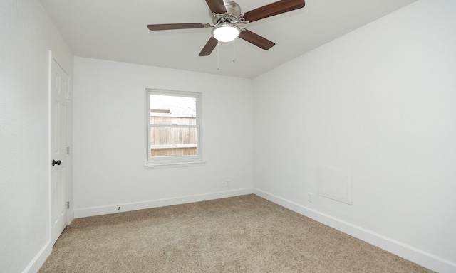 spare room featuring ceiling fan and light colored carpet