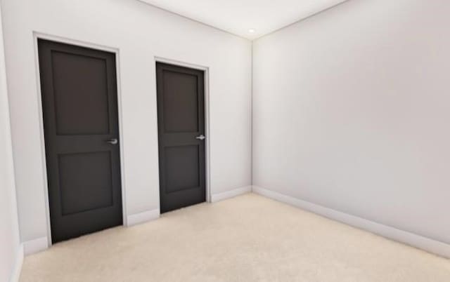 unfurnished bedroom featuring light colored carpet