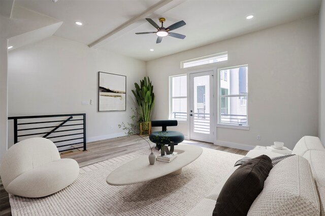 living room with beam ceiling, ceiling fan, and light hardwood / wood-style floors