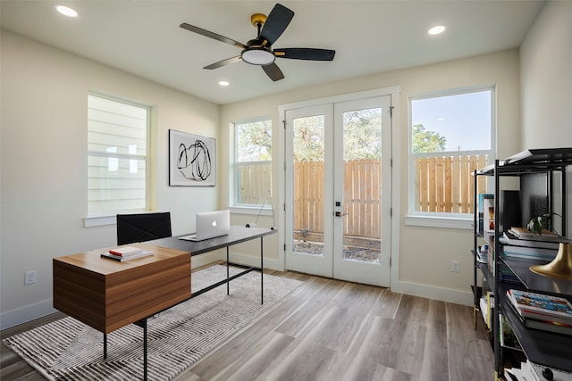 home office with french doors, light hardwood / wood-style flooring, and ceiling fan