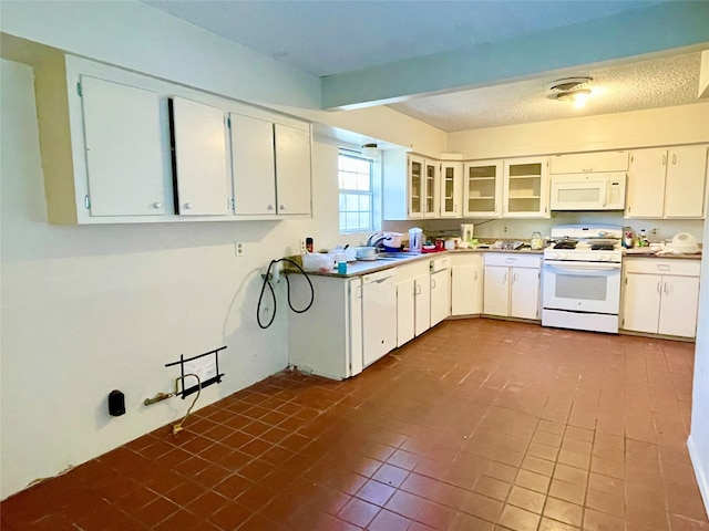 kitchen with white cabinetry, sink, white appliances, and tile patterned flooring