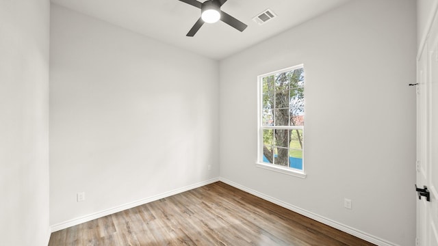 unfurnished room with ceiling fan and light wood-type flooring