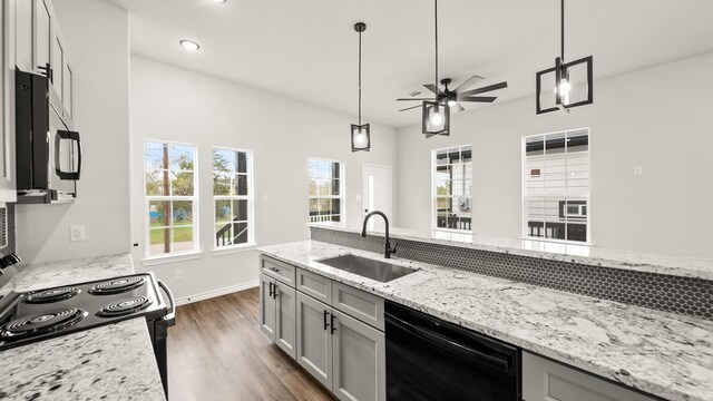 205 3rd St, Rosenberg, TX 77471 - kitchen with a sink, black appliances, ceiling fan, dark wood finished floors, and decorative light fixtures
