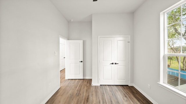 unfurnished bedroom with hardwood / wood-style floors and a closet