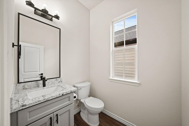 bathroom with vanity, hardwood / wood-style flooring, and toilet