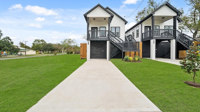 205 3rd St, Rosenberg, TX 77471 - contemporary home featuring stairs, a front lawn, concrete driveway, and stucco siding