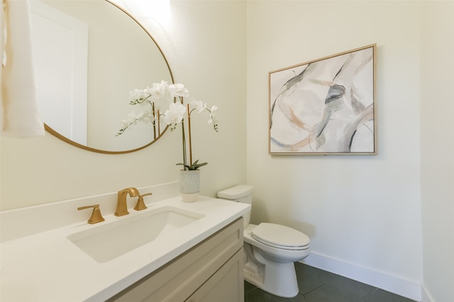 bathroom featuring tile patterned floors, vanity, and toilet