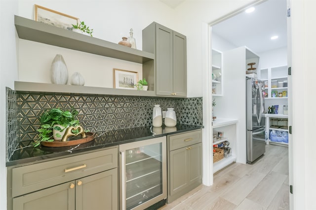 kitchen with wine cooler, gray cabinets, tasteful backsplash, light hardwood / wood-style floors, and stainless steel refrigerator