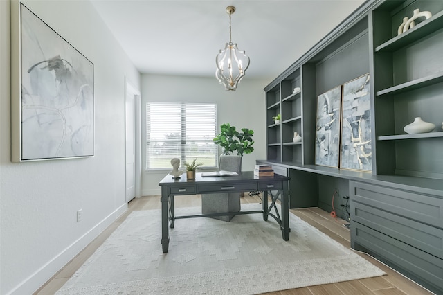 office featuring wood-type flooring and a chandelier