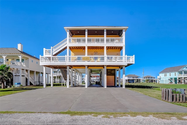 coastal home featuring a carport and a front yard