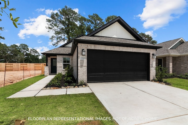 view of front of property with a garage and a front lawn