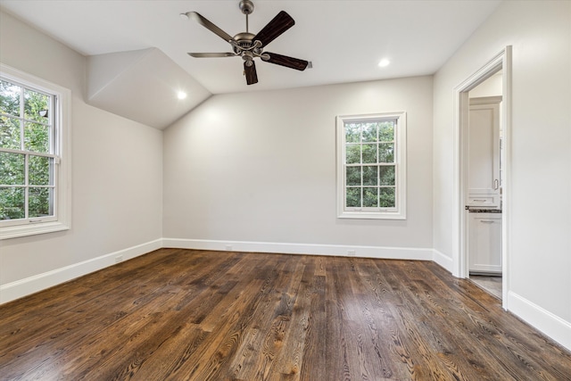 empty room featuring plenty of natural light, ceiling fan, dark hardwood / wood-style flooring, and lofted ceiling