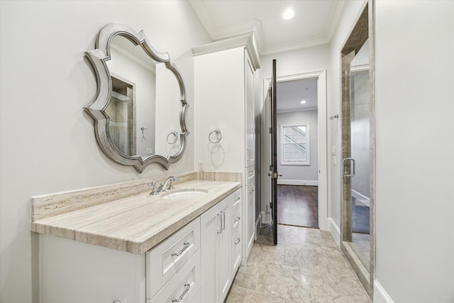 bathroom with wood-type flooring, vanity, and ornamental molding