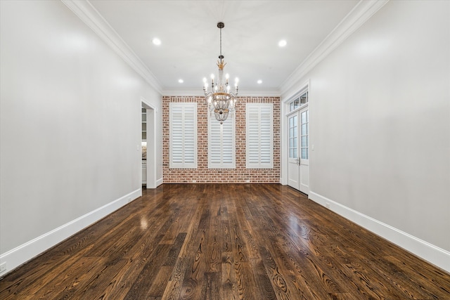 interior space with ornamental molding, dark wood-type flooring, brick wall, and an inviting chandelier