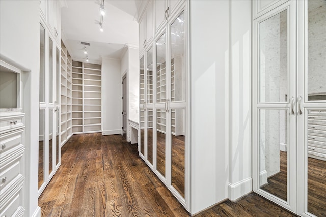 interior space featuring rail lighting and dark hardwood / wood-style floors