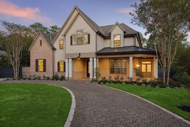 view of front of house featuring a lawn and covered porch