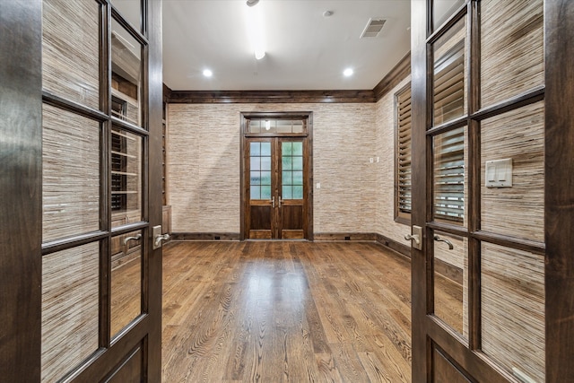 entrance foyer featuring hardwood / wood-style floors and french doors