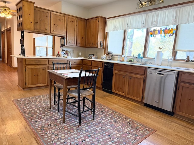 kitchen featuring dishwasher, light hardwood / wood-style floors, sink, and ceiling fan