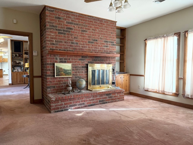 living room with carpet, ceiling fan, and a brick fireplace