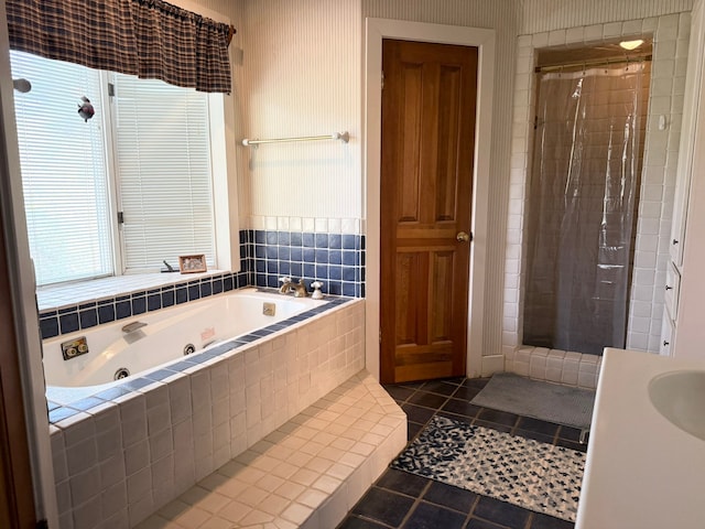 bathroom with tile patterned flooring, separate shower and tub, and sink