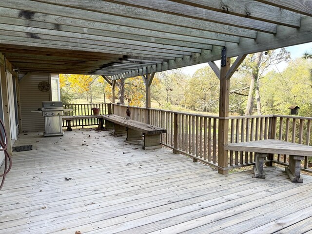 wooden deck featuring a pergola and area for grilling