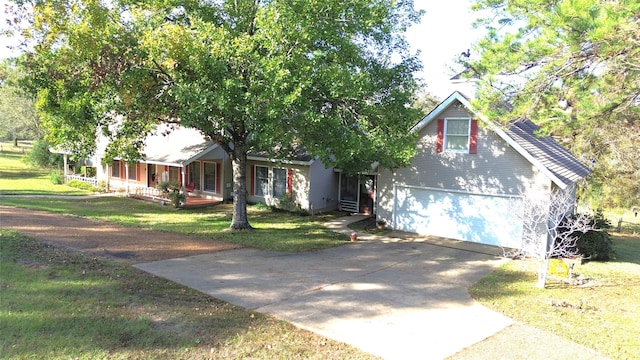 view of front of house with covered porch, a garage, and a front lawn