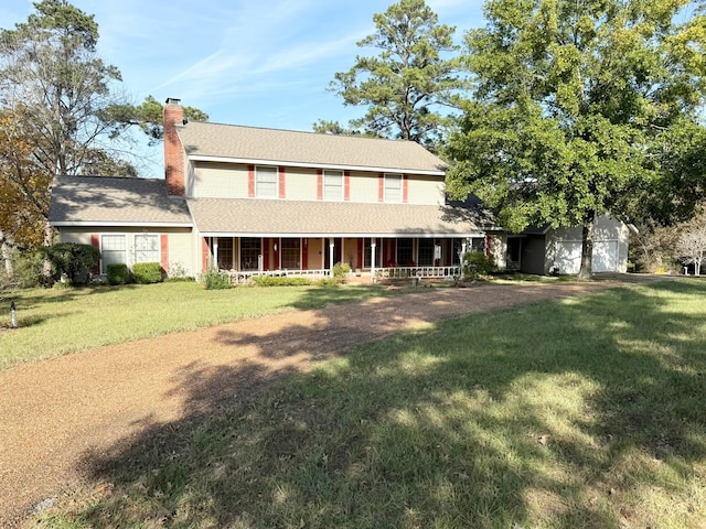 farmhouse-style home with covered porch and a front lawn